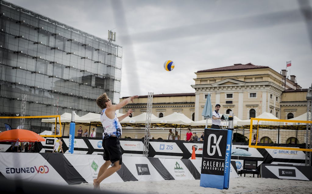 Exciting beach volleyball action captured in a bustling city environment.
